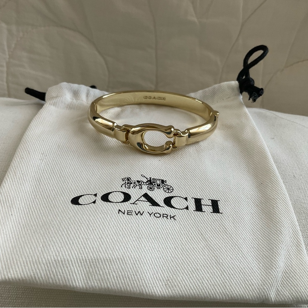 Coach hinged gold tone bracelet